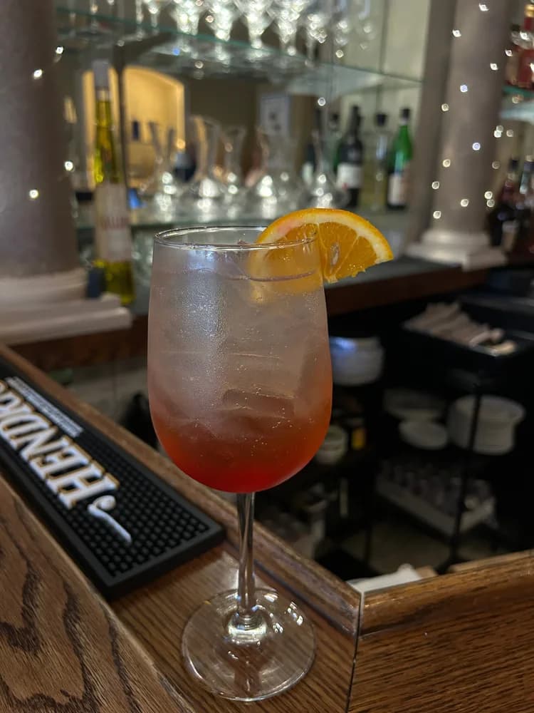 Aperol spritz with an orange slice at the bar