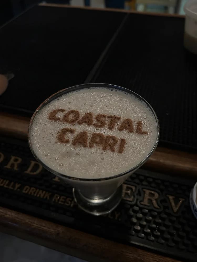 Espresso martini with COASTAL CAPRI stencilled in the foam